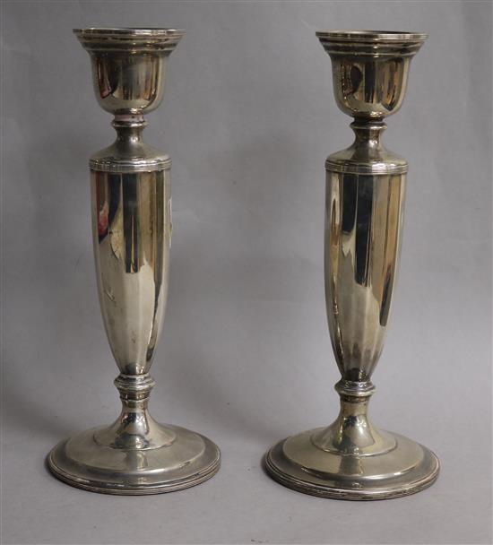 A pair of George V silver candlesticks, 22cm.